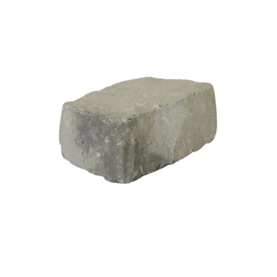 A single gray Apex Masonry Boldstone concrete brick with rough edges from Rockmate Landscapes and Supplies