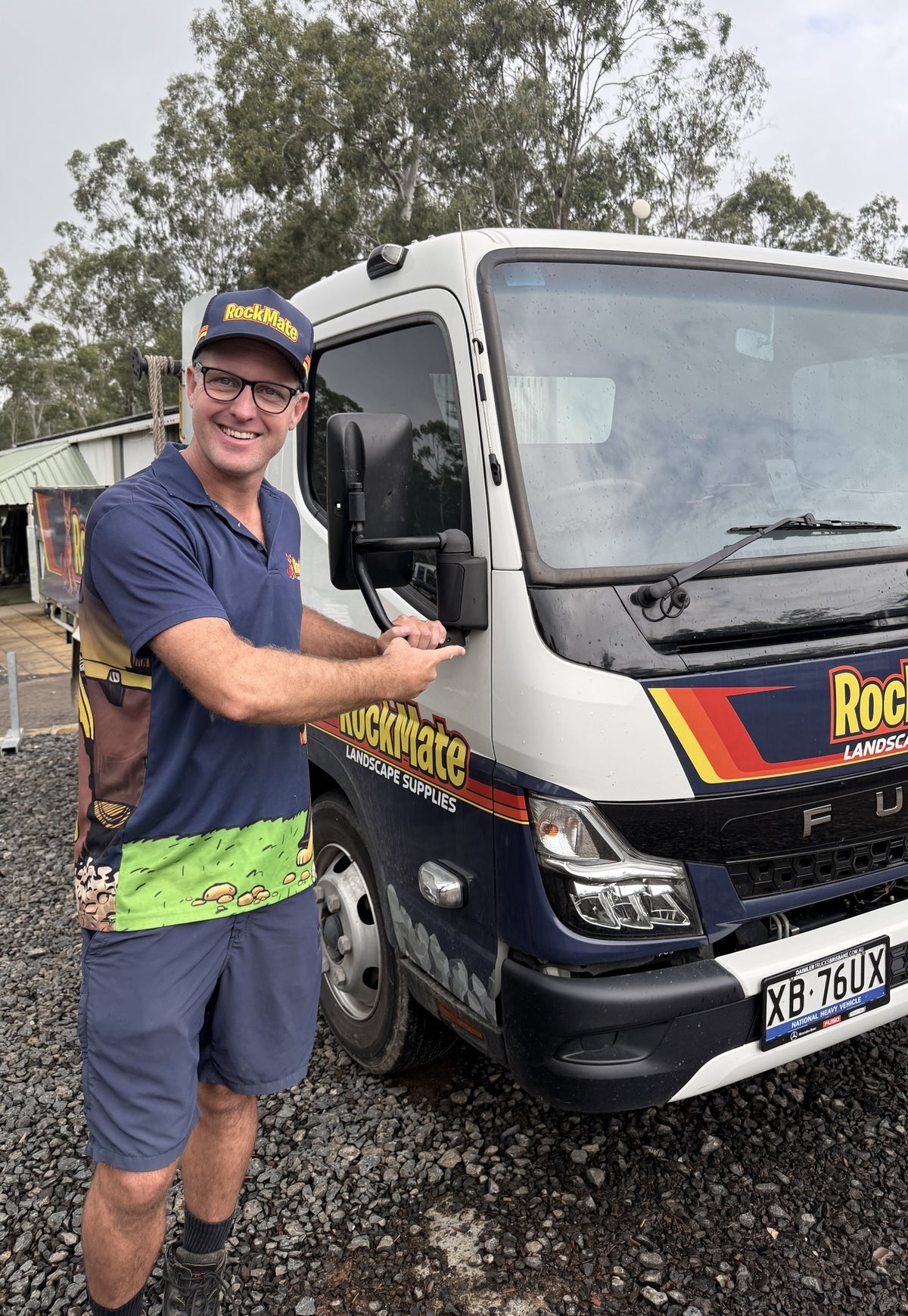 Rockmate driver with a Fuso tipper in the yard