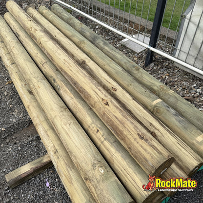 125mm treated pine round logs stacked at the RockMate yard