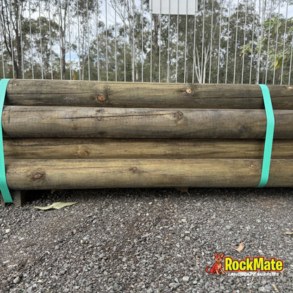 Heavy 150mm H4 treated pine round logs stacked in the yard