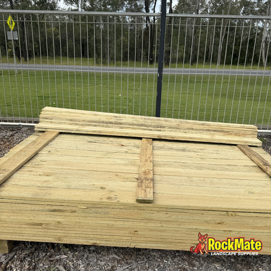 Stack of 1.8m treated pine flat top fence palings