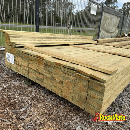 Cut ends of 200 x 50mm treated pine sleepers showing the section size